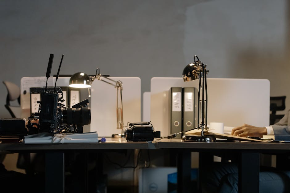 A contemporary office setup featuring desks with lamps.